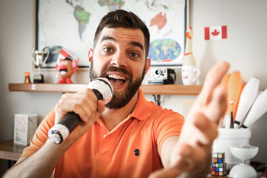 Teacher Michael with a microphone prop